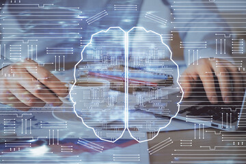 Businessman with computer background with brain theme hologram. Concept of brainstorm. Multi...