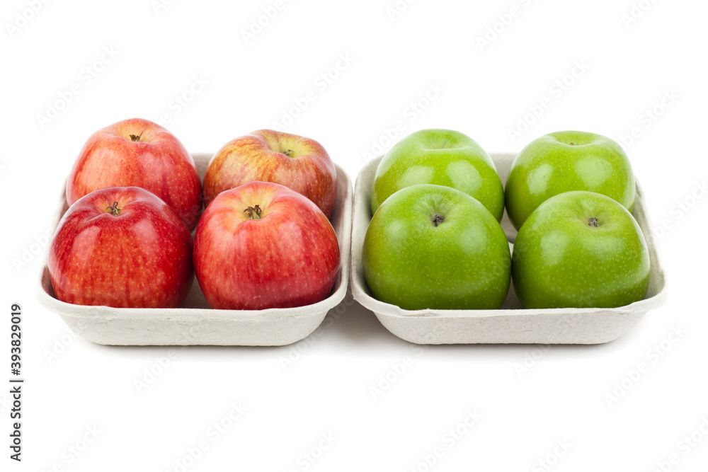 Wall mural Fresh red and green apples in pulp paper trays next to each other. Studio photo isolated on white.