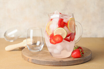 Jug of fresh strawberry lemonade on wooden board
