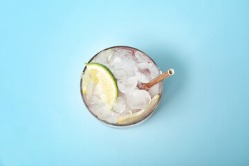 Glass of fresh strawberry lemonade on color background