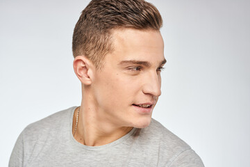 Fototapeta premium Cheerful emotional man gray t-shirt gesturing with hands studio lifestyle