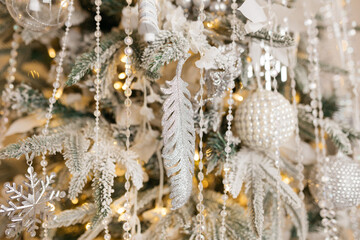 Christmas tree decoration: Christmas glass toys, flickering garlands. concept: an example of the...