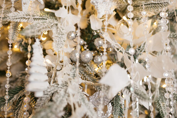 Christmas tree decoration: Christmas glass toys, flickering garlands. concept: an example of the...