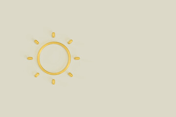 Vitamin D Capsules in the shape of Sun on Light Gray Background with Copy Space.