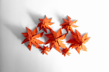 Paper Christmas trees, red fir trees with shadows on white background, top view