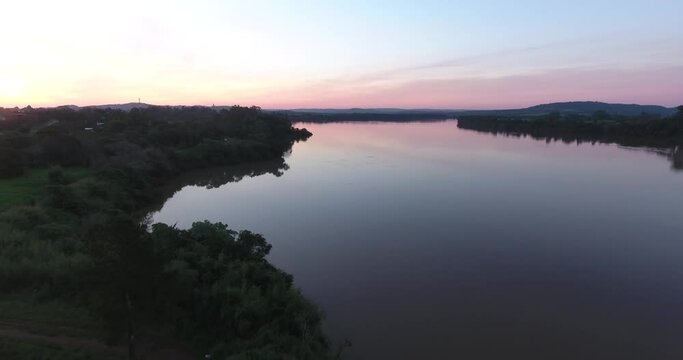 Aerial view of a large river at sunset.  Purple image of the golden hour over the Uruguay River.