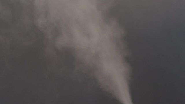Water mist puff cloud from humidifier black background. Vapor.