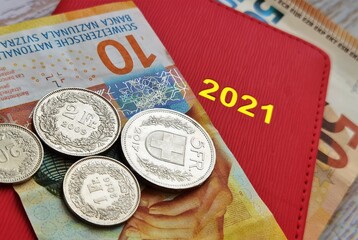 Obraz premium red notepad calendar and swiss and european money