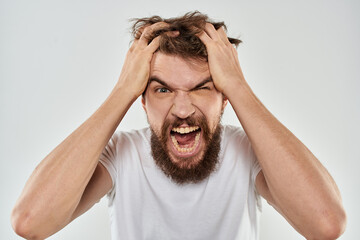 emotional man with a beard gesturing with his hands close-up studio aggression