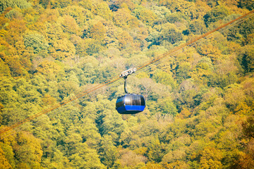 Cable way to the mountains at sunny day time.