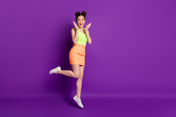 Full length body size view of attractive fit delighted cheery girl jumping enjoying good mood isolated on vibrant violet color background