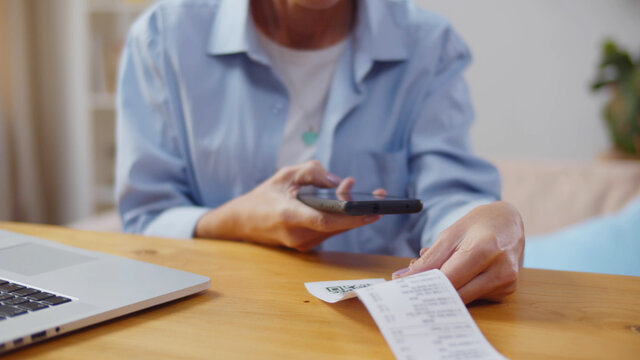 Woman Using Smartphone And Scanning Qr Code Paying Bills Online