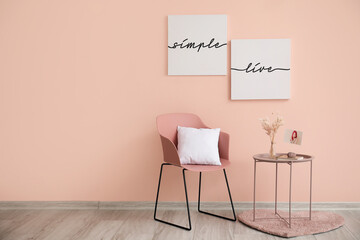 Chair and table near color wall in room