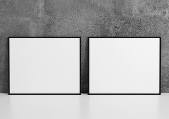 Two horizontal black frame mockups. Black frame poster on a gray concrete wall. 3D illustrations.