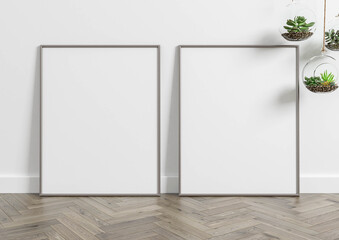 Vertical metal frame mockup. Metal frame poster on wooden floor with white wall and plants. 3D illustrations. 2 Frames Mockup