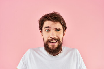 Fototapeta premium Man in white t-shirt gestures with hands emotions lifestyle cropped view pink background