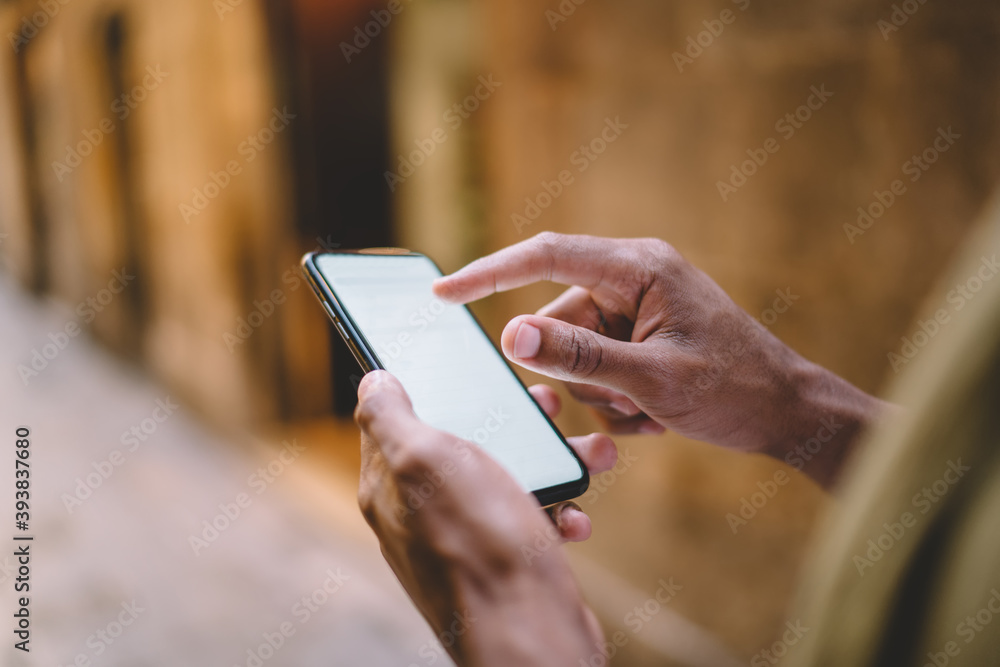 Poster cropped image on man's hand holding smartphone sending and checking income messages,male using mobil