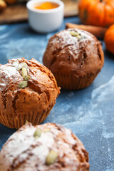 Tasty pumpkin muffins on color background