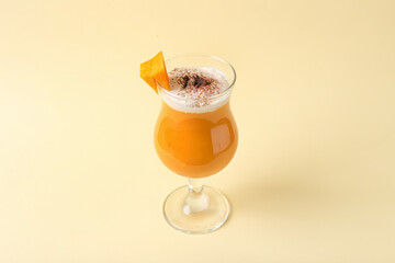 Glass of tasty pumpkin smoothie on color background