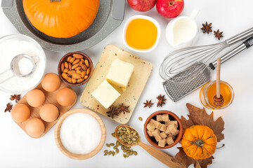 Ingredients for preparing pumpkin pie on white background