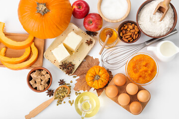 Fototapeta na wymiar Ingredients for preparing pumpkin pie on white background