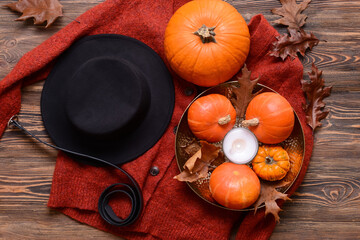 Beautiful autumn composition with clothes on wooden background