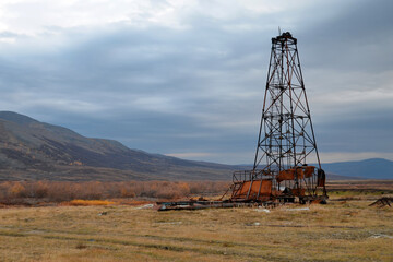 Abandoned derrick in the mountainous tundra. Polar Ural, Yamalo-Nenets Autonomous Okrug (Yamal), Russia.