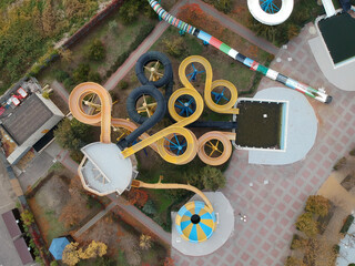 Aerial photo of small aqua park with colorful tubes, view from above, abandoned, nobody