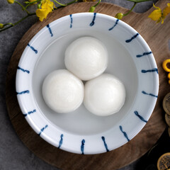 Top view of big tangyuan yuanxiao in a bowl on gray background for lunar new year food.