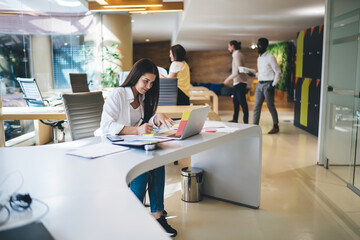 Obraz premium Caucasian female e learning with webinar how programming laptop code sitting in modern coworking space for freelancers, skilled woman browsing communication service during networking on technology