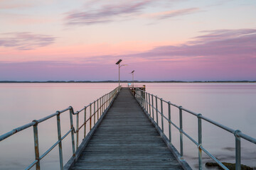 A long exposure pastel sunset over the Robe wooden jetty lcoated in Robe South Australia on...
