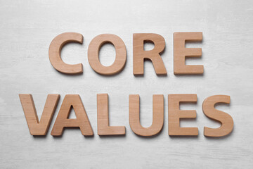 Phrase CORE VALUES made of wooden letters on white background, flat lay