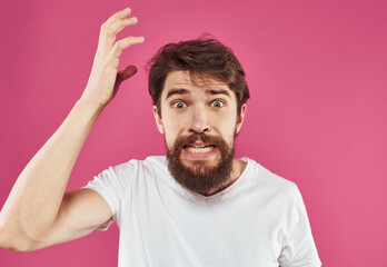 Fototapeta na wymiar angry man with beard holds hands near face and stress irritability