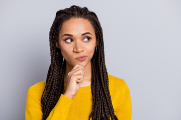 Photo of young african woman think deep guess wonder brainstorming plan look empty space isolated...