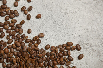 Top view of coffee beans on cement floor, copy space.