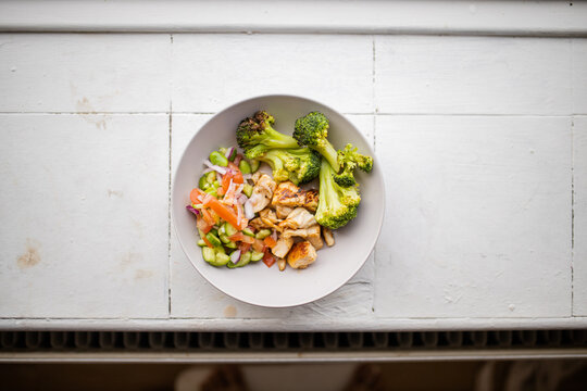 Broccoli And Chicken Salad From Above On White Counter