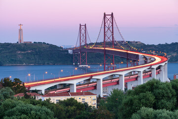 Lisbon 25 de Abril bridge and Jesus Christ statue Cristo Rei at sunset, best view of Lisbon, in Portugal