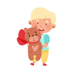 Flushed Boy Character with Blonde Hair Holding Bear Toy with Bow Vector Illustration