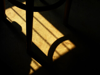 shadow of chair on the floor with light from the window in the room