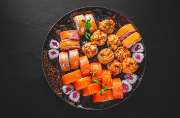 set of sushi roll with salmon, avocado, cream cheese, cucumber, rice, tuna in plate on black background