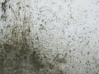 splash of dry cement on white concrete wall in construction site