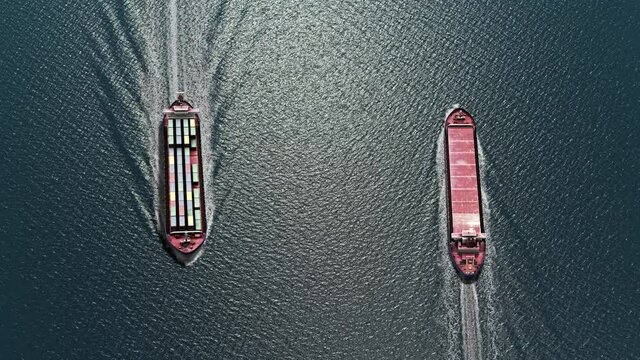 Two cargo ships sailing close, one to dock and one to leave Harbor
Aerial top view on clear day, Container ship Export import Goods 
