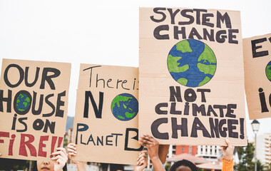 Group of demonstrators on road, young people from different cultures protest for climate change - Global warming and enviroment concept - Focus on banners - obrazy, fototapety, plakaty