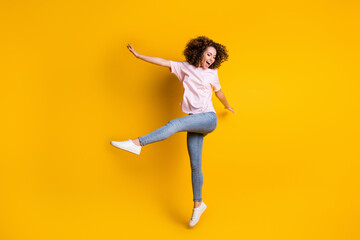 Photo portrait full body view of crazy girl jumping up kicking isolated on vivid yellow colored background