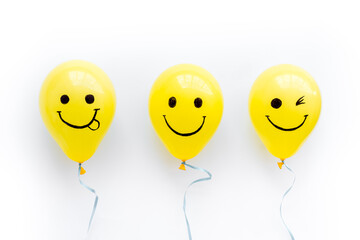 Positive emotions set. Happy and winking emoticons painted on colored balloons