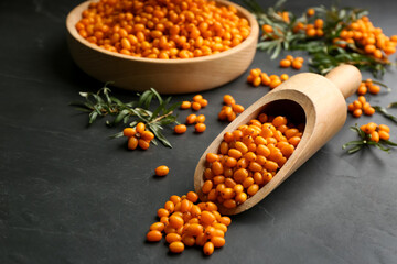 Fresh ripe sea buckthorn on black table