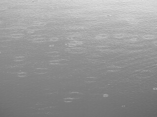 ripple of rain drops falling on the water surface