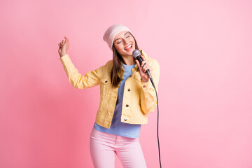 Photo of funky cute lady dance sing song wear cap jacket trousers isolated on pastel pink color background