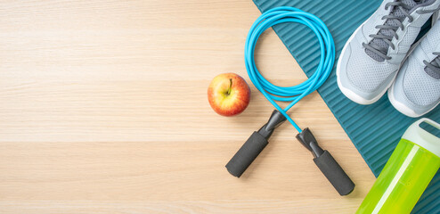 Fitness equipment on a wooden background with copyspace