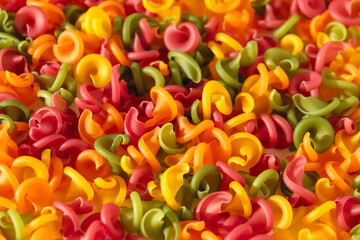 Multicolored pasta as a background image. Top view. Copy, empty space for text